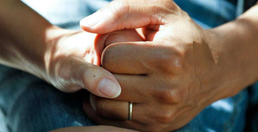 person wearing gold wedding band